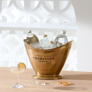 https://s3-ap-southeast-2.amazonaws.com/fusionfactory.commerceconnect.bbnt.production/pim_media/000/174/086/M_F_Summer_S24-25_LS_Studio_Barware-Champagne_Bucket_Flared_Brass.jpg?1729746510